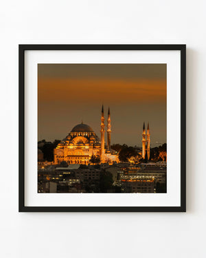 Illuminated mosque and minarets at dusk in Istanbul Turkey
