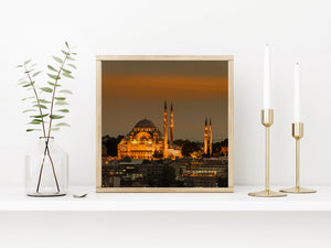 Warm toned mosque architecture above Istanbul rooftops at night