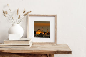 Istanbul religious landmark lit against orange sunset clouds