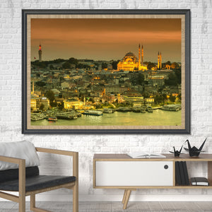 A glowing mosque and dense city skyline overlook Istanbul’s waterfront in warm sunset light.