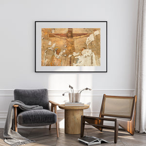 Cracked wall painting with a cross and ochre background