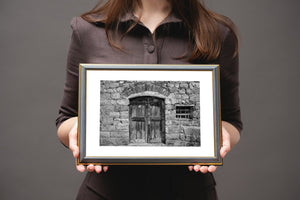 Textured stone wall with antique wooden door