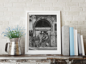 Weathered urban doorway with mural on metal shutter Tivoli Italy