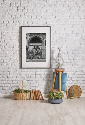 Mural of woman working painted on roll down gate in Tivoli