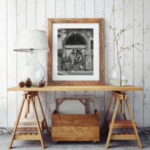 Old stone doorway with metal gate mural black and white Italy