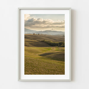 Rolling hills and farmhouse in the countryside of Tuscany Italy