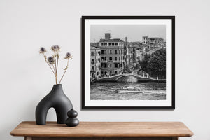 Street scene in Venice featuring arched footbridge and canal