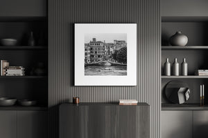 People gathering on Venice bridge above quiet canal