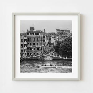 Venice canal with bridge and water taxi in black and white
