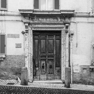 old Italian stone doorway with aged wooden doors