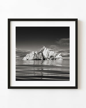 Black and white iceberg floating in Iceland glacier lagoon