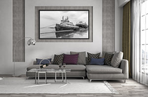 Monochrome harbour scene with tugboat and wet pavement
