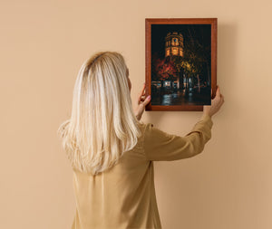Sapporo landmark clock tower glowing under street lights at night