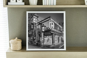 Corner restaurant exterior in Tokyo with illustrated shutter doors