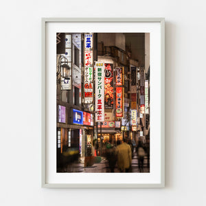 Tokyo Shinjuku alley with vertical neon signs at night