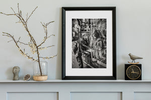 candid portrait of Tokyo vendor sitting among merchandise