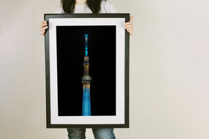 Blue lit steel lattice of Tokyo Skytree at night