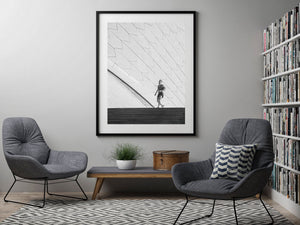 Black and white contrast between a jogger and architectural geometry