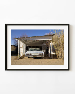 Classic white Chevrolet beneath a weathered carport in Keeler California