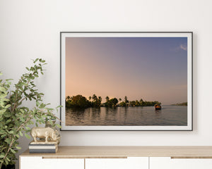 Kerala sunset landscape with a boat leaving a gentle wake