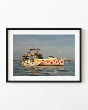 Key West houseboat with red circles painted across its white hull