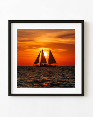 Charter sailboat silhouette at sunset off Florida coast