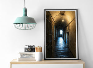 Colour photograph of a dim corridor and iron bars at Kilmainham Gaol