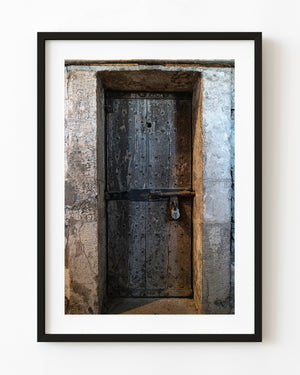 Weathered cell door and padlock at Kilmainham Gaol in Dublin
