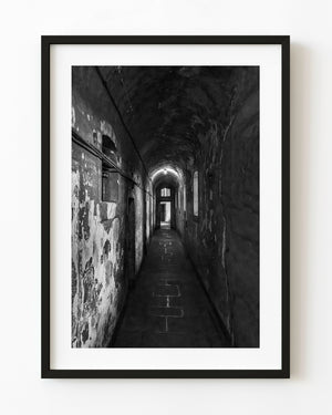 Narrow corridor at Kilmainham Gaol in black and white