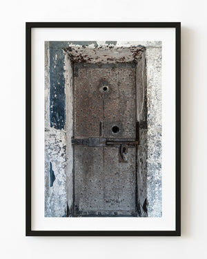 Weathered Kilmainham Gaol cell door with a bolt and padlock
