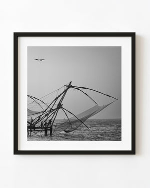 Kochi fishing nets silhouetted at dusk in black and white