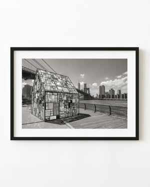 Kolonihavehus glass installation beneath Brooklyn Bridge in black and white.