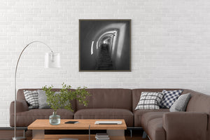 Black and white architectural photograph of a long arched passage in Havana.