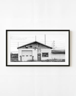 Lake Nipigon bait shop with a wooden gable and tackle sign in black and white.
