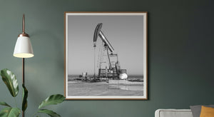 Industrial pumpjack and fenced equipment beside the Lake Ontario horizon.