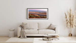 Layered cliffs stretch across the horizon beyond Lake Powell at sunrise.