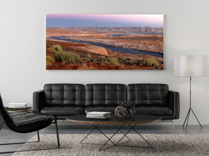 Colour panorama of Lake Powell’s sandstone landscape beneath a soft pink dawn sky.