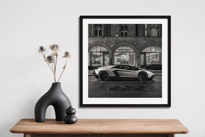 Luxury car parked under storefront lights in London