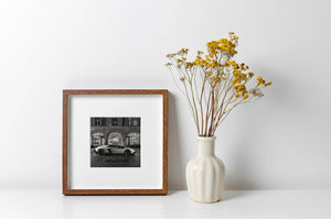 Nighttime urban scene featuring exotic car and architecture