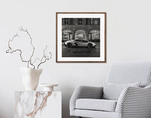 City street scene with Lamborghini and illuminated boutique