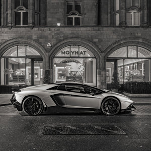 Black and white photo of supercar in upscale London street