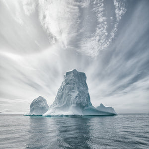Large iceberg floating off Antarctica coast with overcast sky above