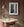 curious young Buddhist monk framed by patterned monastery window