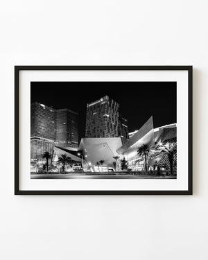 Crystals shopping complex and Las Vegas towers illuminated at night in black and white.