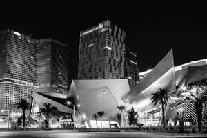 Angular Las Vegas architecture beneath tall hotel towers against a dark sky.