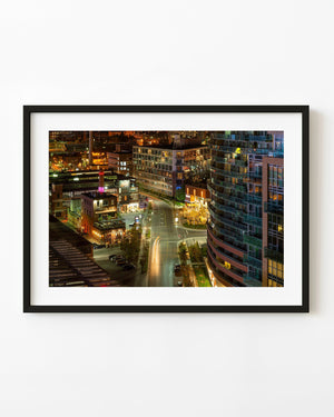 Liberty Village Toronto at night with illuminated buildings and curving street light trails.