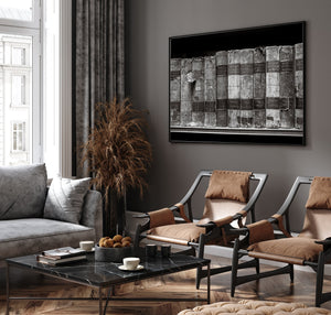 Modern living room with gray sofa, brown chairs, and abstract art on the wall.