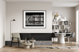Modern interior with a framed black and white abstract art piece on the wall.