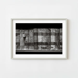 Row of worn English law books on a library shelf