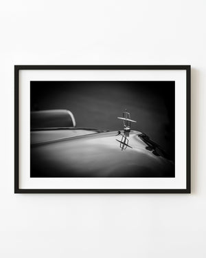 Lincoln Continental hood ornament with reflection in black and white